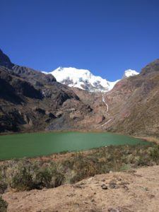 Bright green lake in front of a glacier