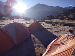 sun rising over frost covered tents