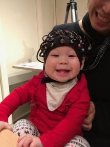 Baby wearing a cap to measure their brain activity