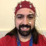 James in a EEG cap which has electrodes on his head and face