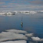 Argo float floating in the sea surrounded by sea ice