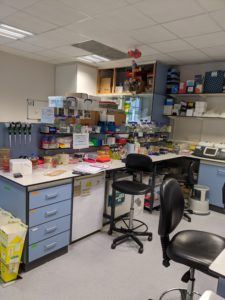 A laboratory bench covered in boxes of equipment