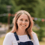 Photograph of Lizzie smiling taken outside.