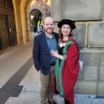 Lizzie in her graduation robes with her partner James.