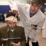 Two actors dressed as a solider and an army doctor.