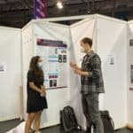 A photo of me at a neuroscience conference explaining my research to a fellow scientist.
