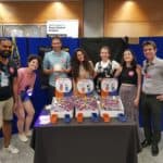 A photo of me with my colleagues at the Great exhibition Road Festival 2022 posing in front of the AI-educational activity we demonstrated.